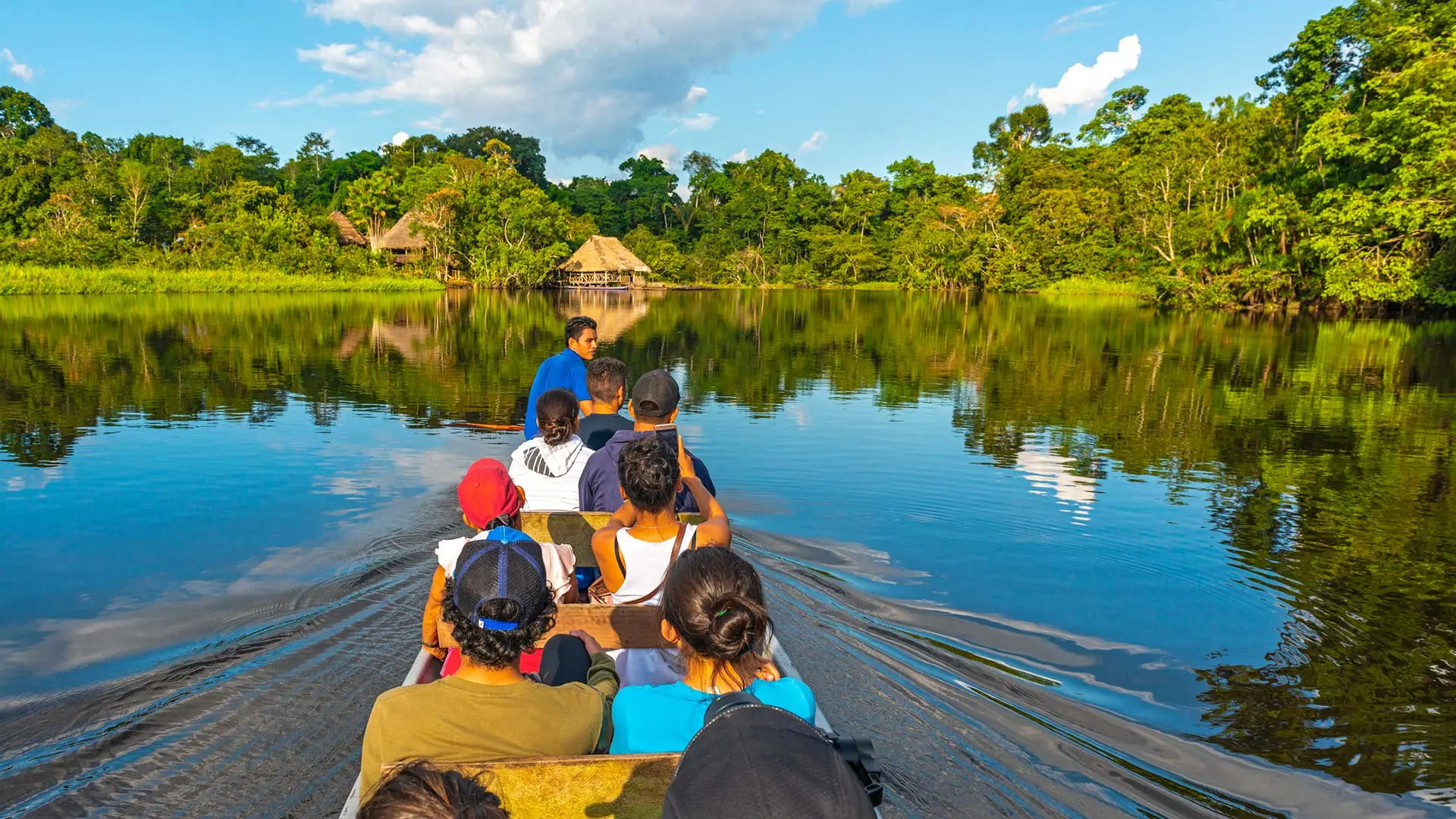 Travelers exploring the Peruvian Amazon by boat