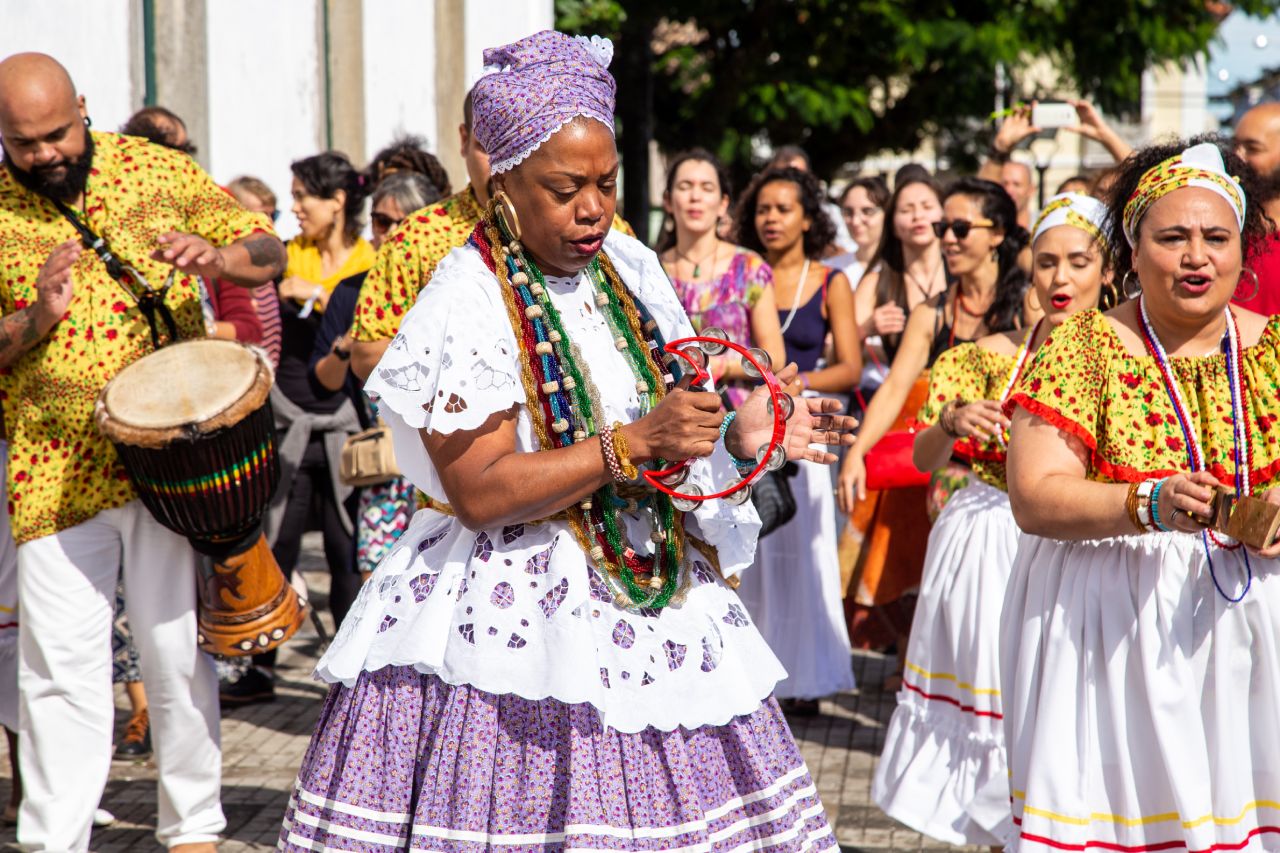 Afro-Brazilian women dancing and playing tambourine during a cultural festival