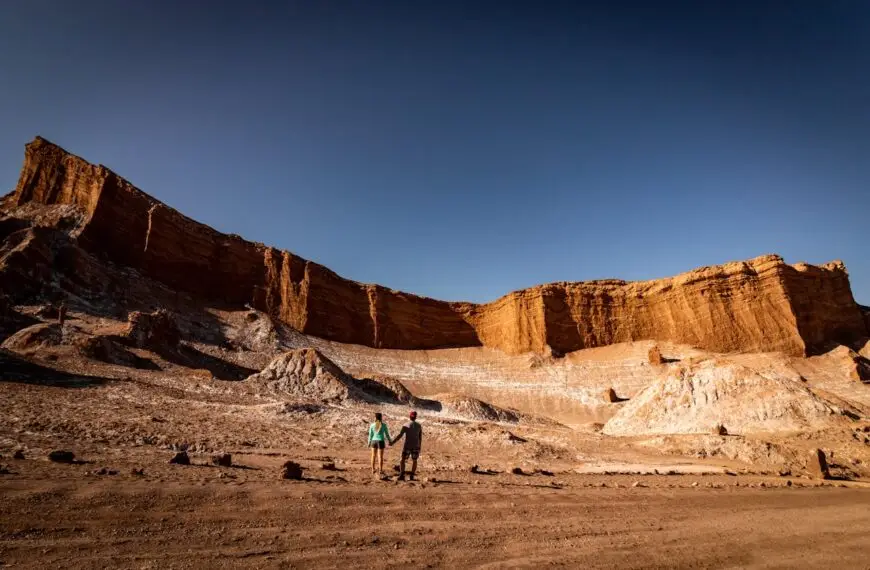 Tourists admiring sandstone cliffs in Atacama Desert